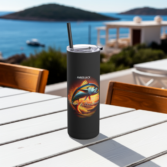 Black birth month travel tumbler with amberjack fish design on a white outdoor table by the sea