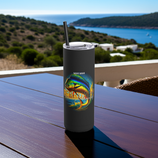 Black birth month travel tumbler with colorful mahi mahi fish graphic on outdoor table overlooking sea