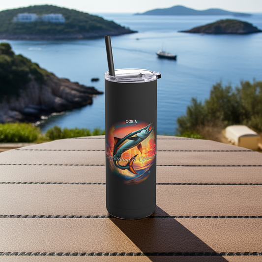 Birth month travel tumbler with colorful fish graphic on black background outdoors