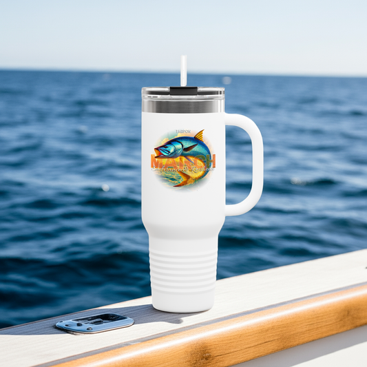 White birth month travel mug with colorful fish design on boat railing by ocean