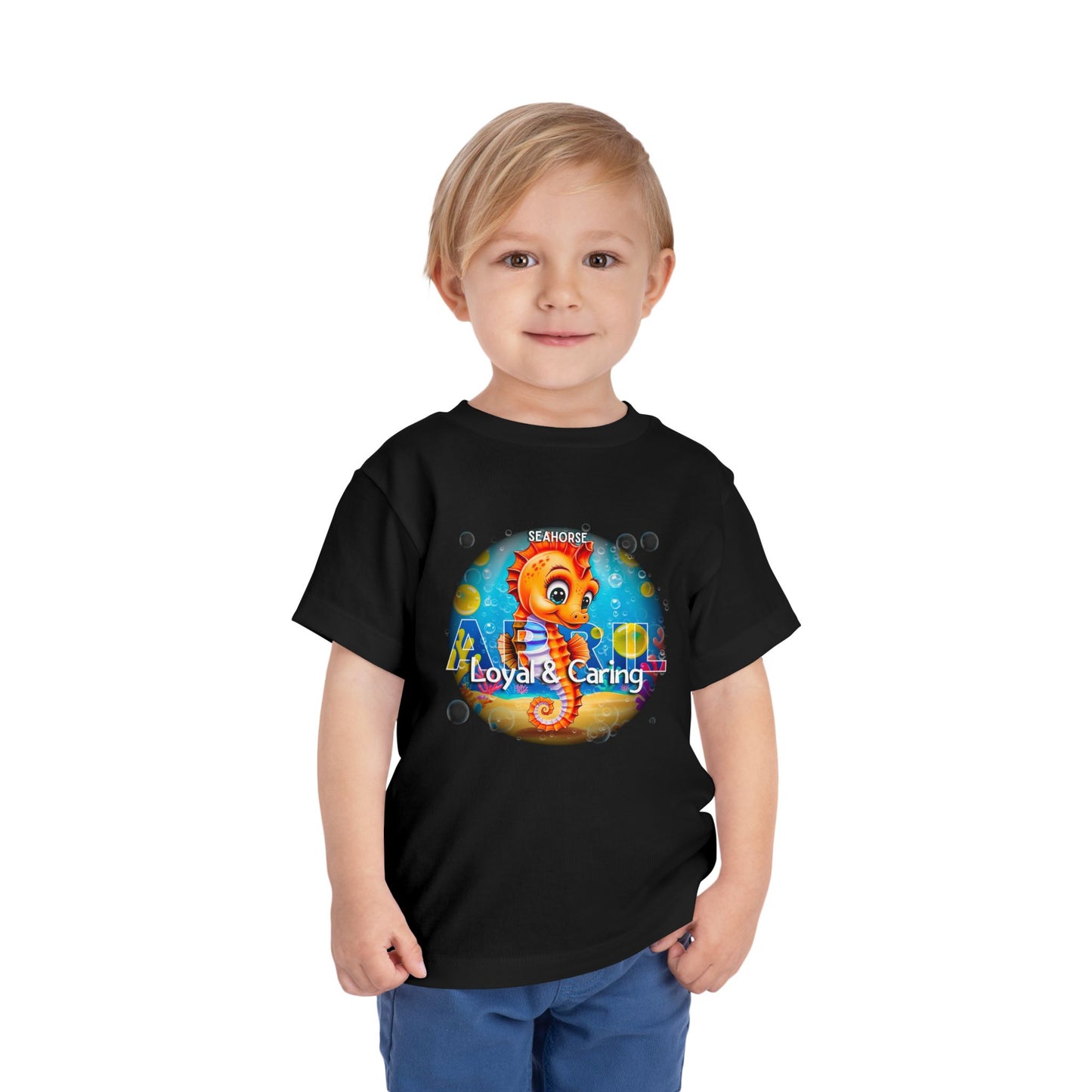 Kids birth month tshirt featuring a colorful seahorse design labeled Loyal and Caring on black kids clothes