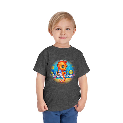 Toddler wearing a dark gray kids birth month tshirt featuring a colorful seahorse design with Loyal and Caring text