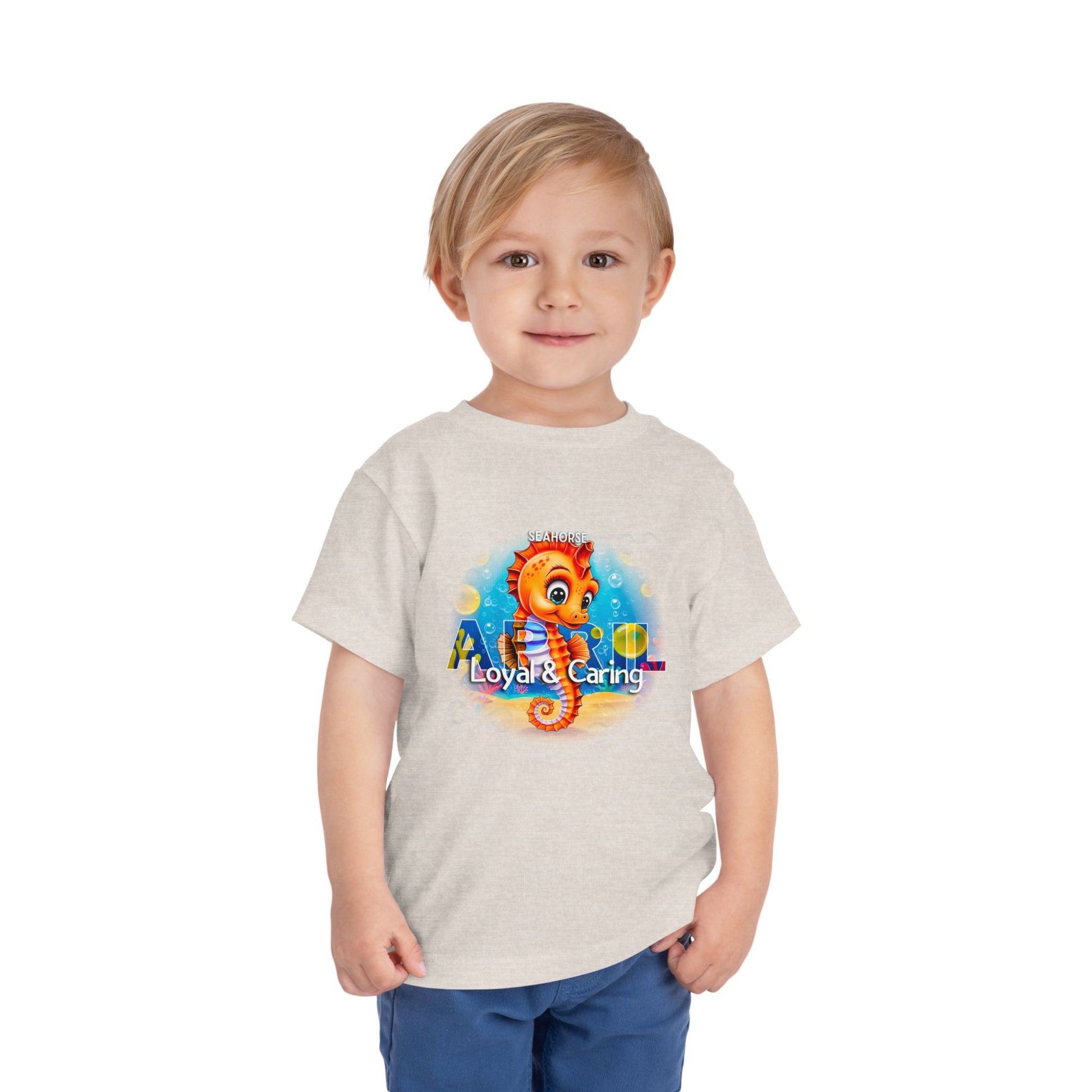 Toddler wearing a kids birth month tshirt with colorful seahorse graphic from kids clothes