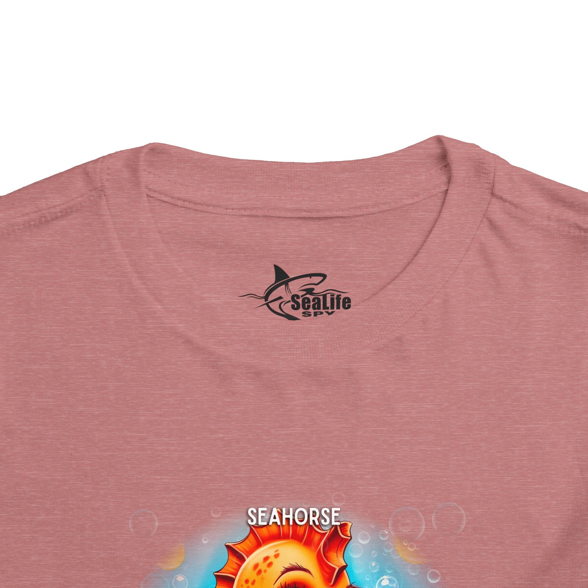 Kids birth month tshirt featuring a colorful seahorse design on a pink fabric