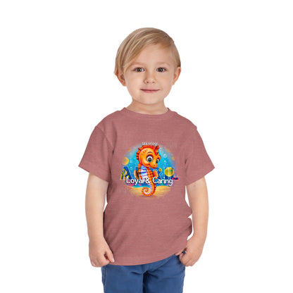 Toddler wearing kids birth month tshirt with colorful seahorse design and loyal caring text