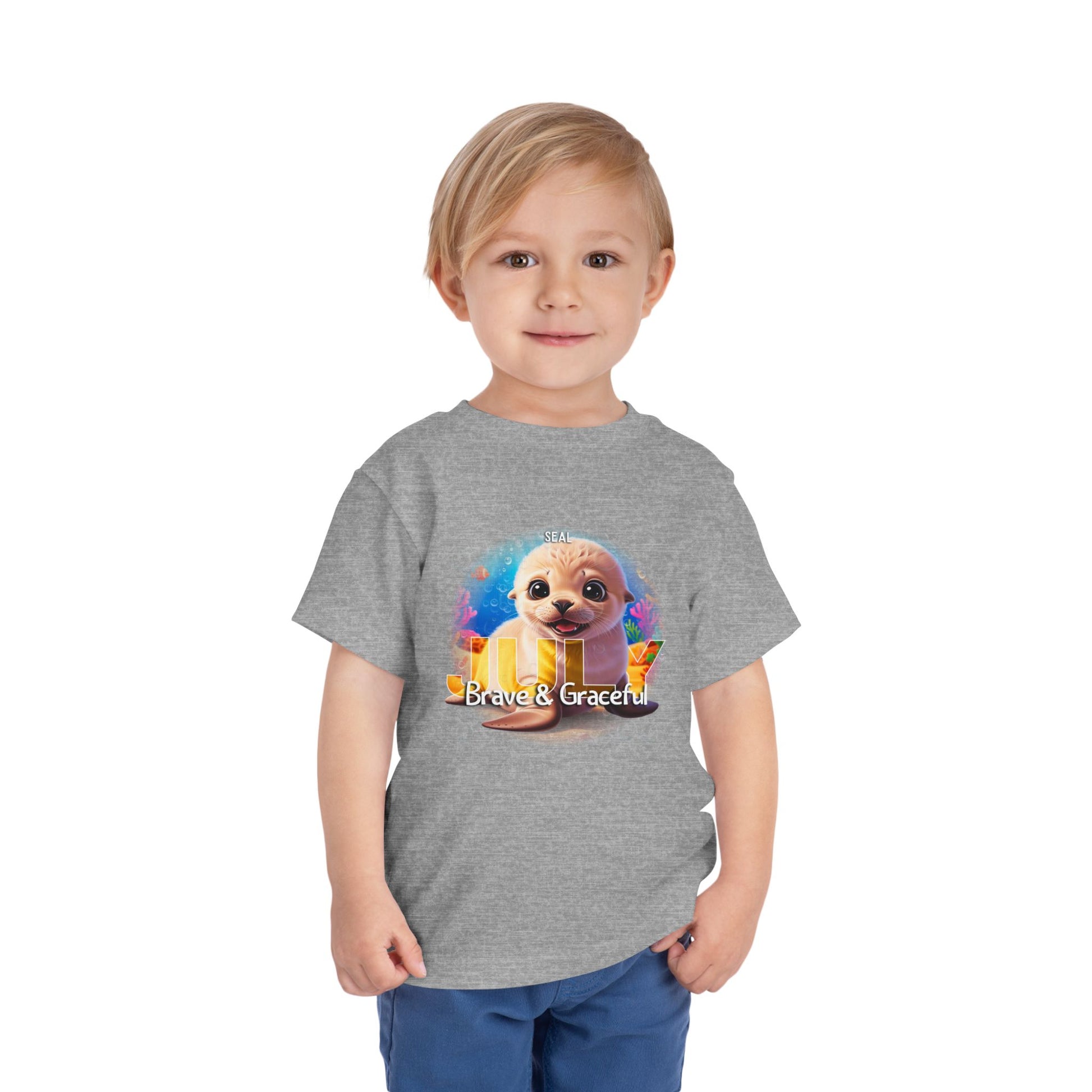 Toddler wearing grey kids birth month tshirt with cute puppy and Brave & Graceful design