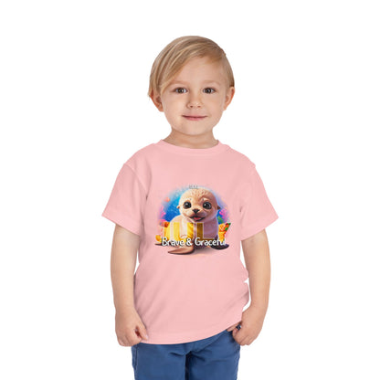 Toddler wearing a pink kids birth month tshirt with a cute seal and Brave & Graceful text