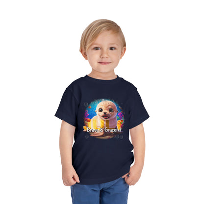 Toddler wearing navy kids birth month tshirt with colorful sea otter graphic and brave and graceful text