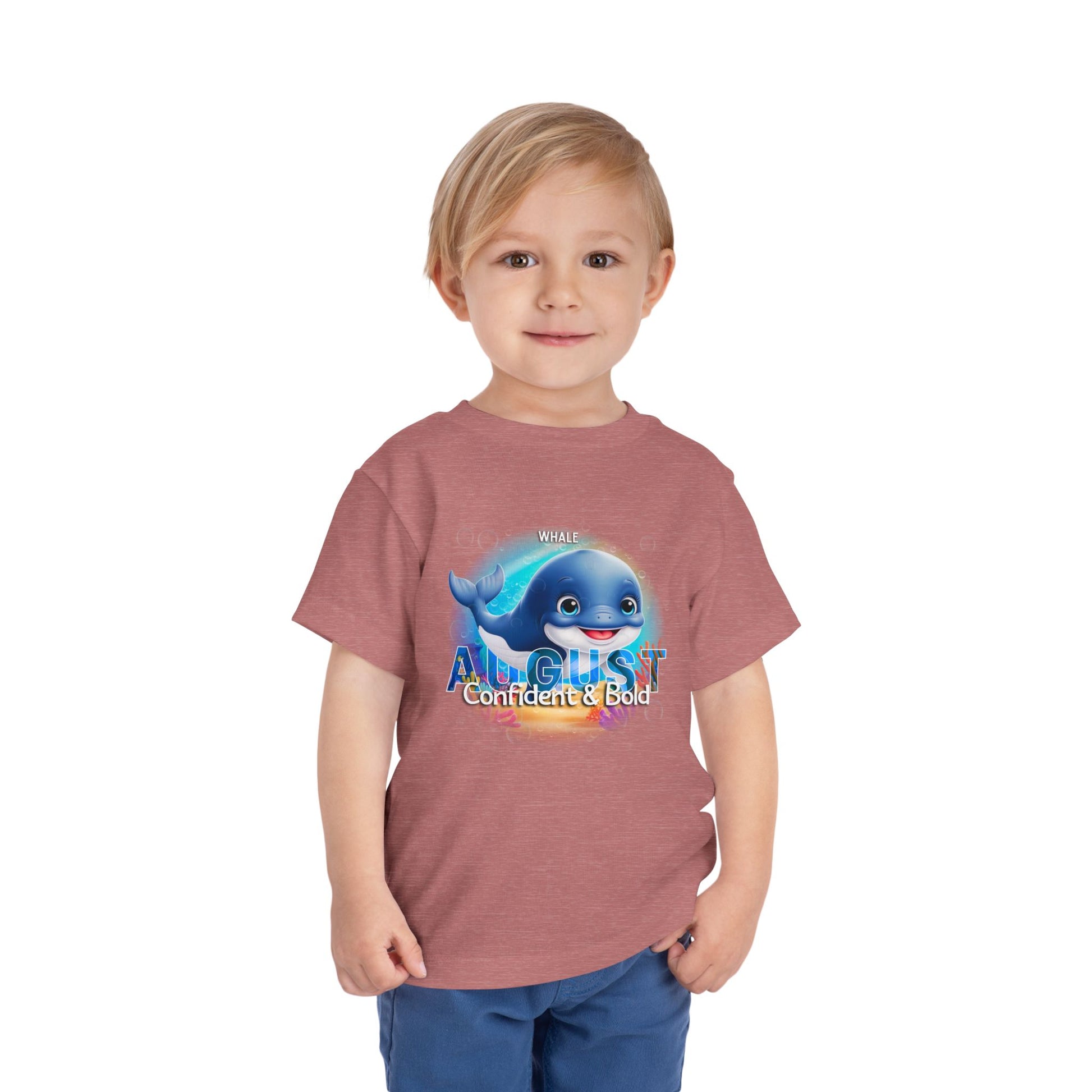 Kids birth month tshirt August with whale graphic worn by young boy in blue shorts