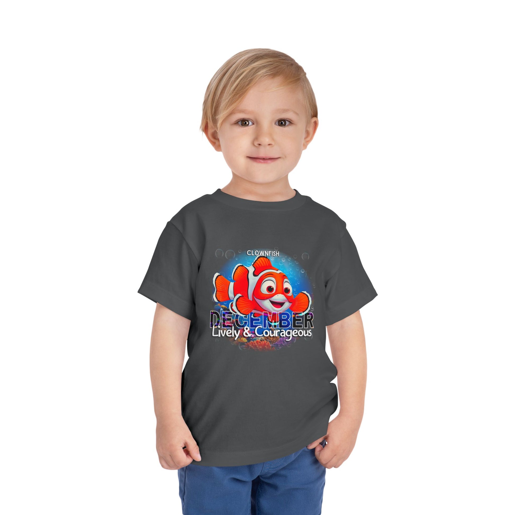 Child wearing kids birth month tshirt with colorful clownfish and December text design