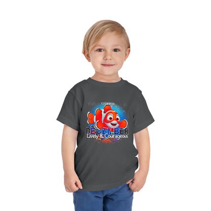 Child wearing kids birth month tshirt with colorful clownfish and December text design
