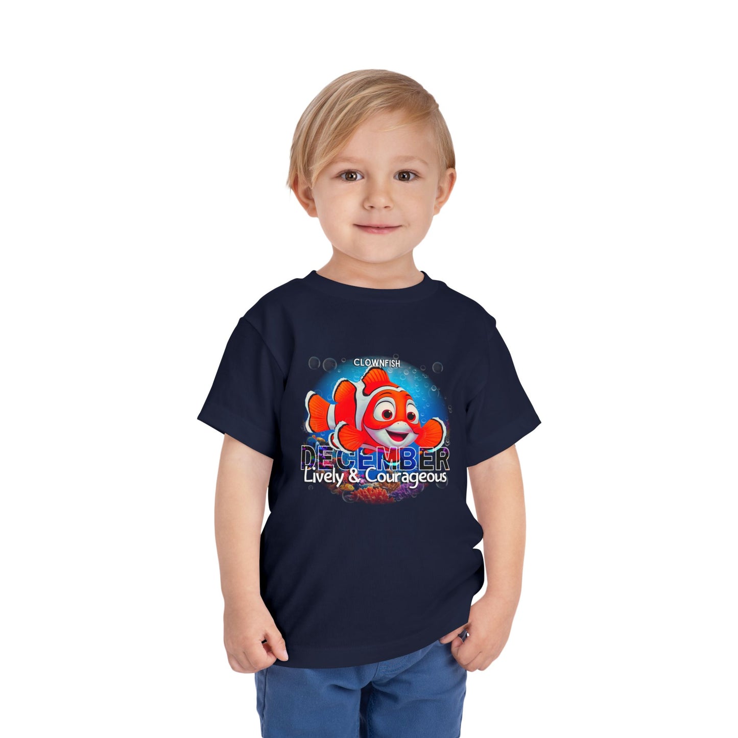 Toddler wearing navy kids birth month tshirt with December clownfish design and positive traits