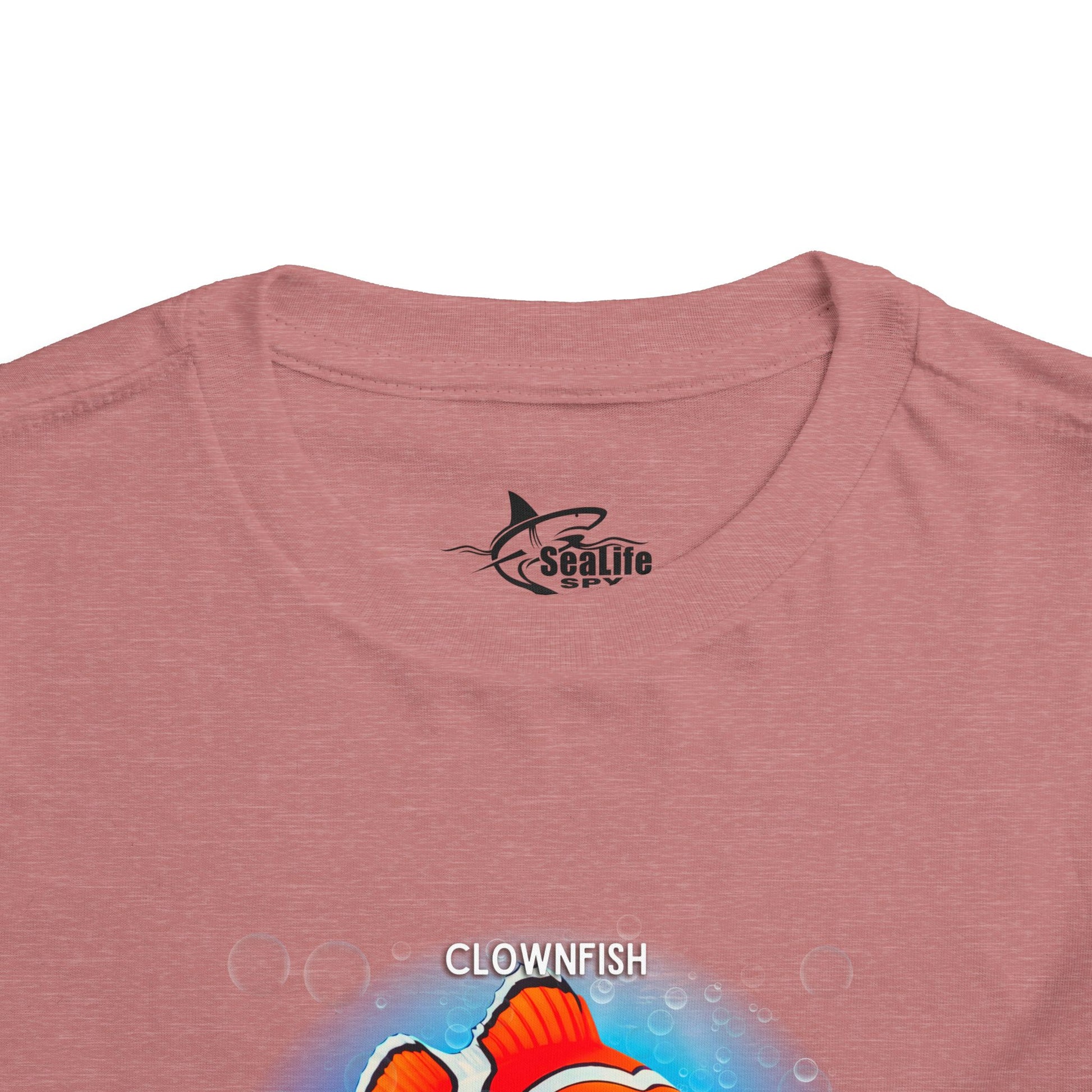 Kids birth month tshirt with colorful clownfish graphic on pink fabric