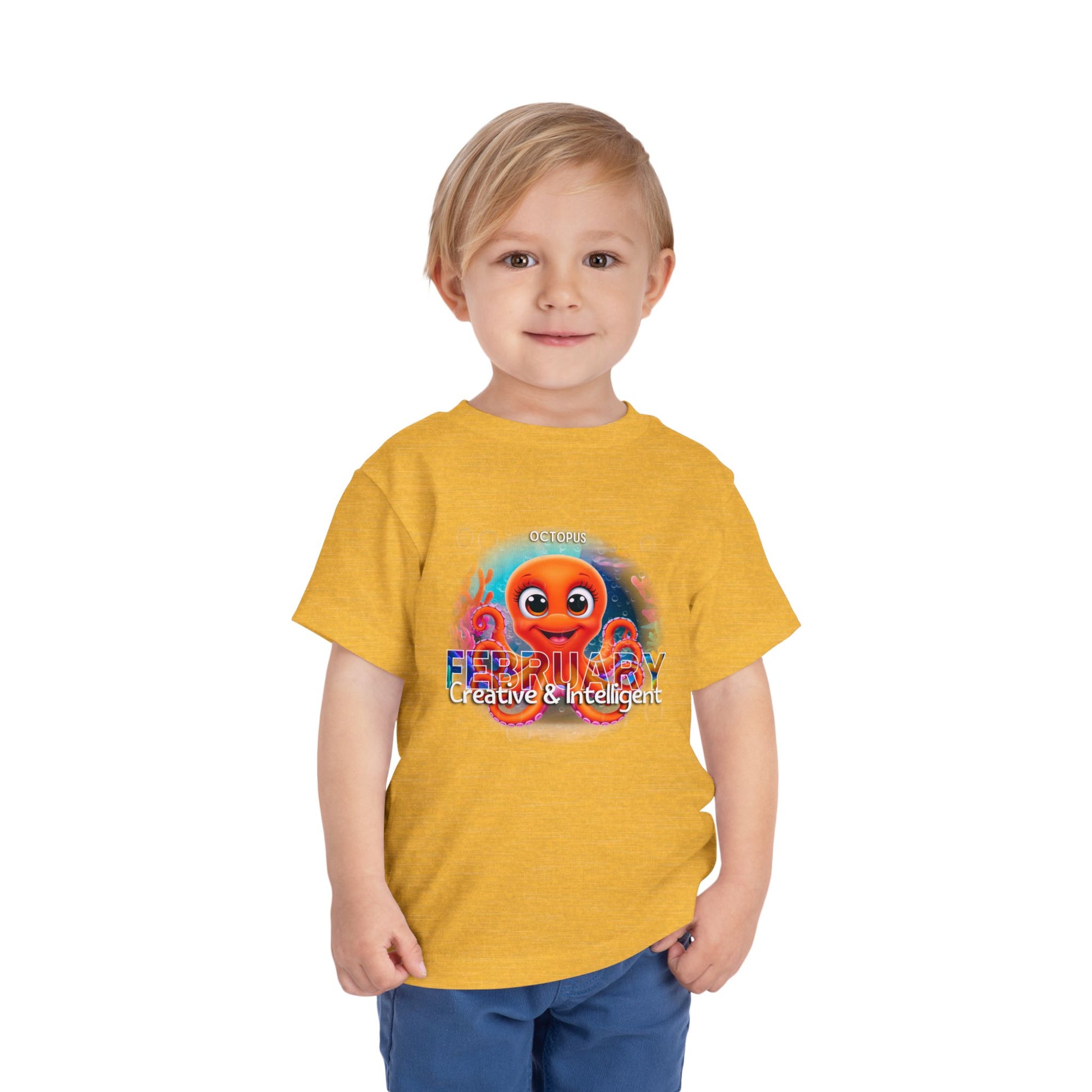 Young boy wearing a yellow kids birth month tshirt with colorful octopus design and creative text