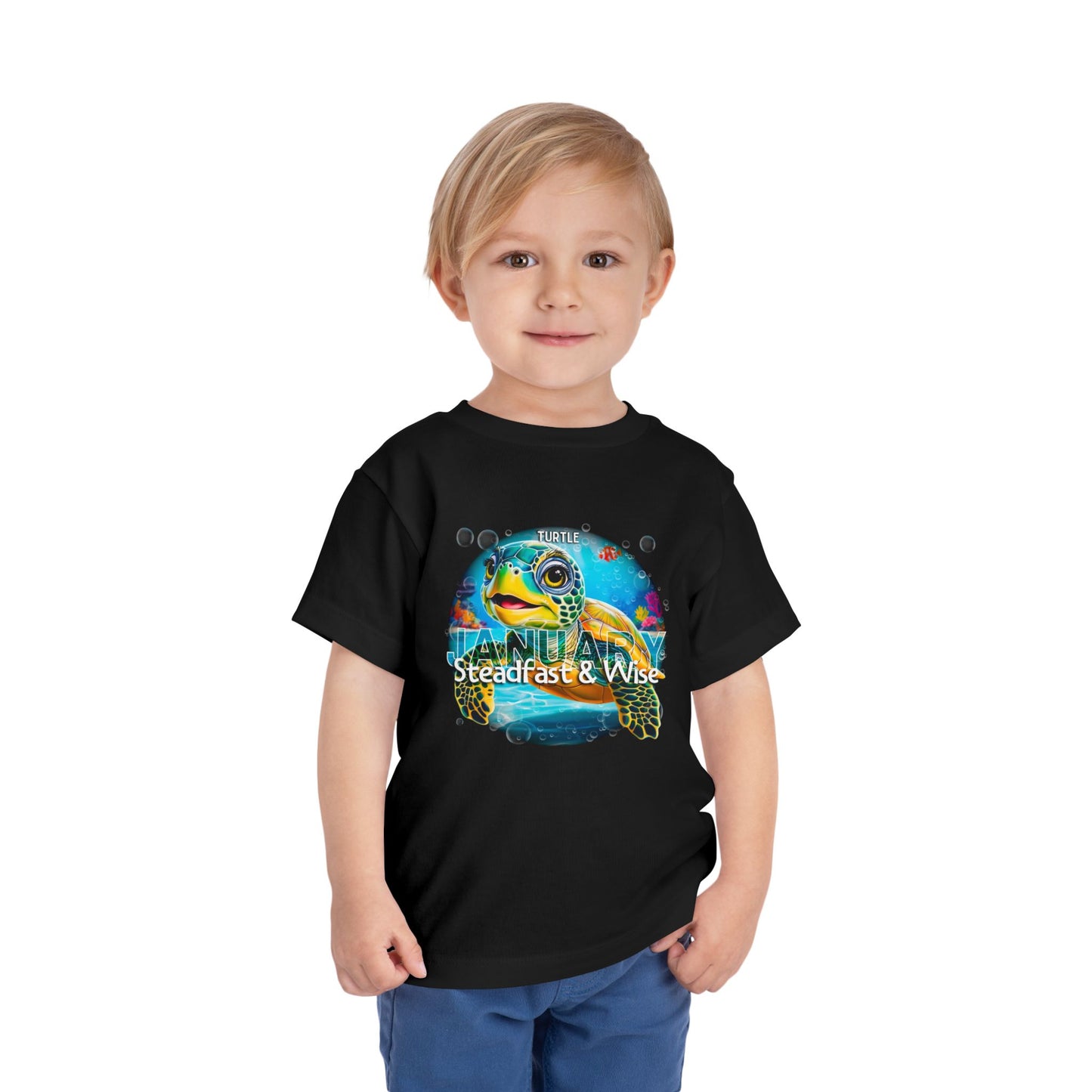 Boy wearing black kids birth month tshirt with colorful sea turtle design for January 