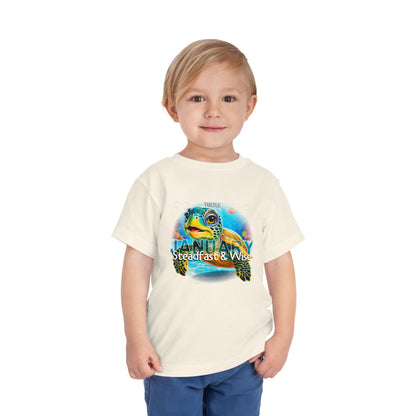 Toddler wearing kids birth month tshirt with January turtle design 