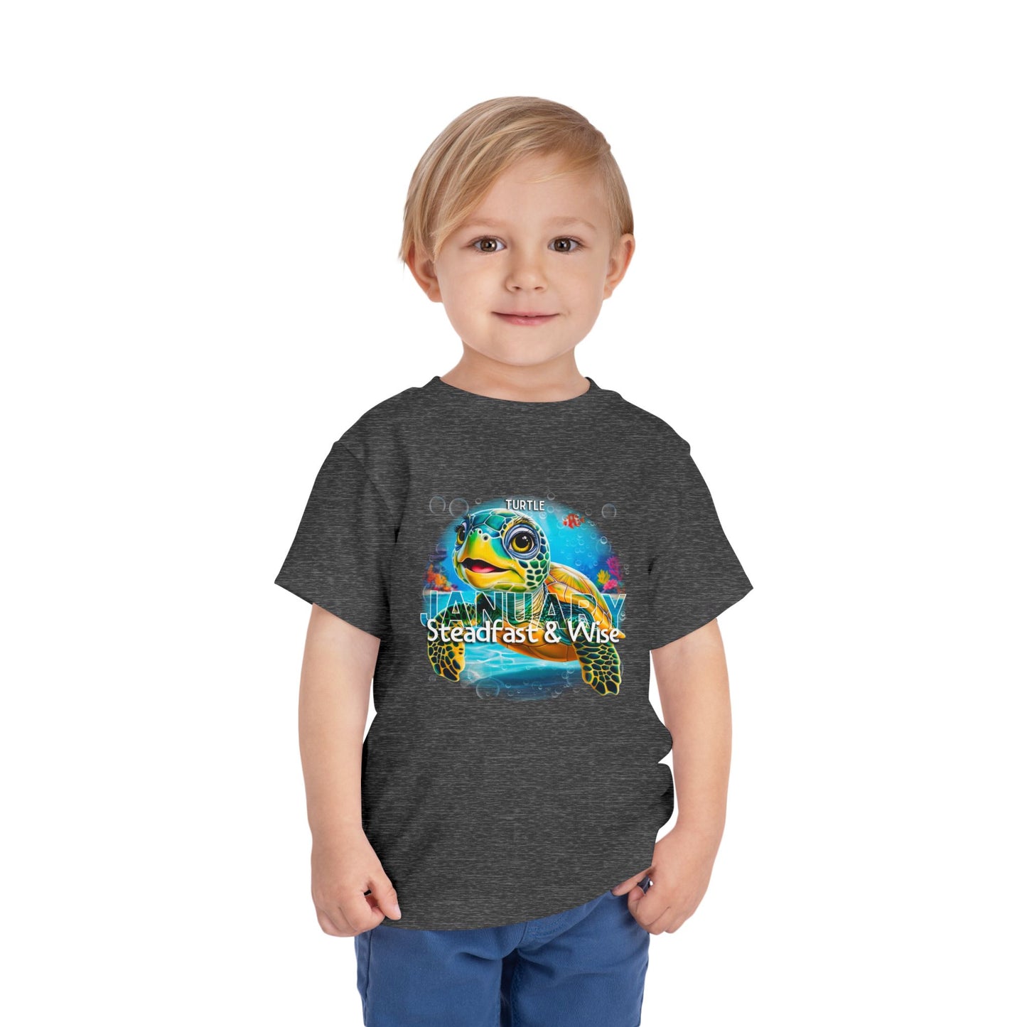 Child wearing a kids birth month tshirt with a colorful turtle design for January