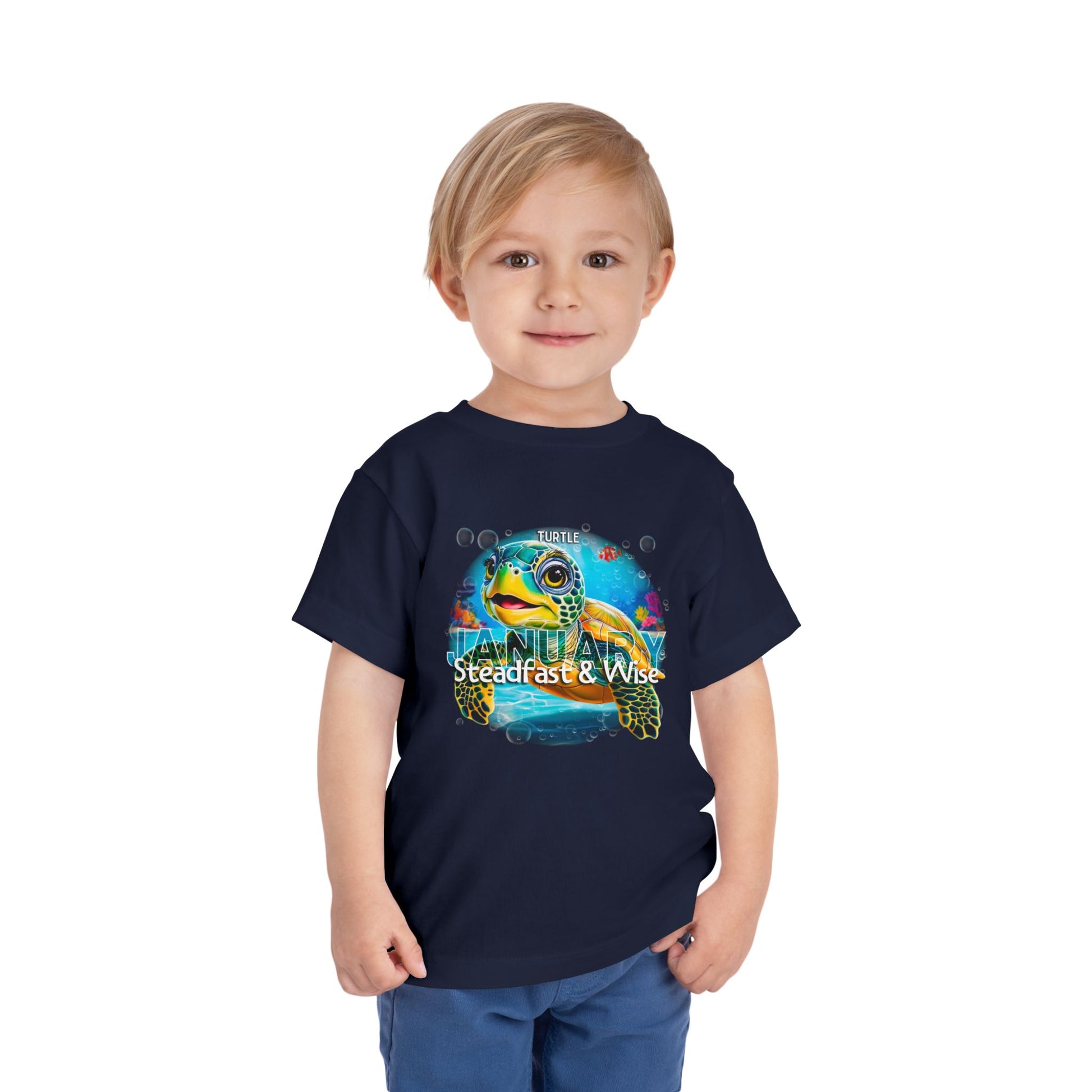 Boy wearing navy kids birth month tshirt with colorful turtle and steady wise January design