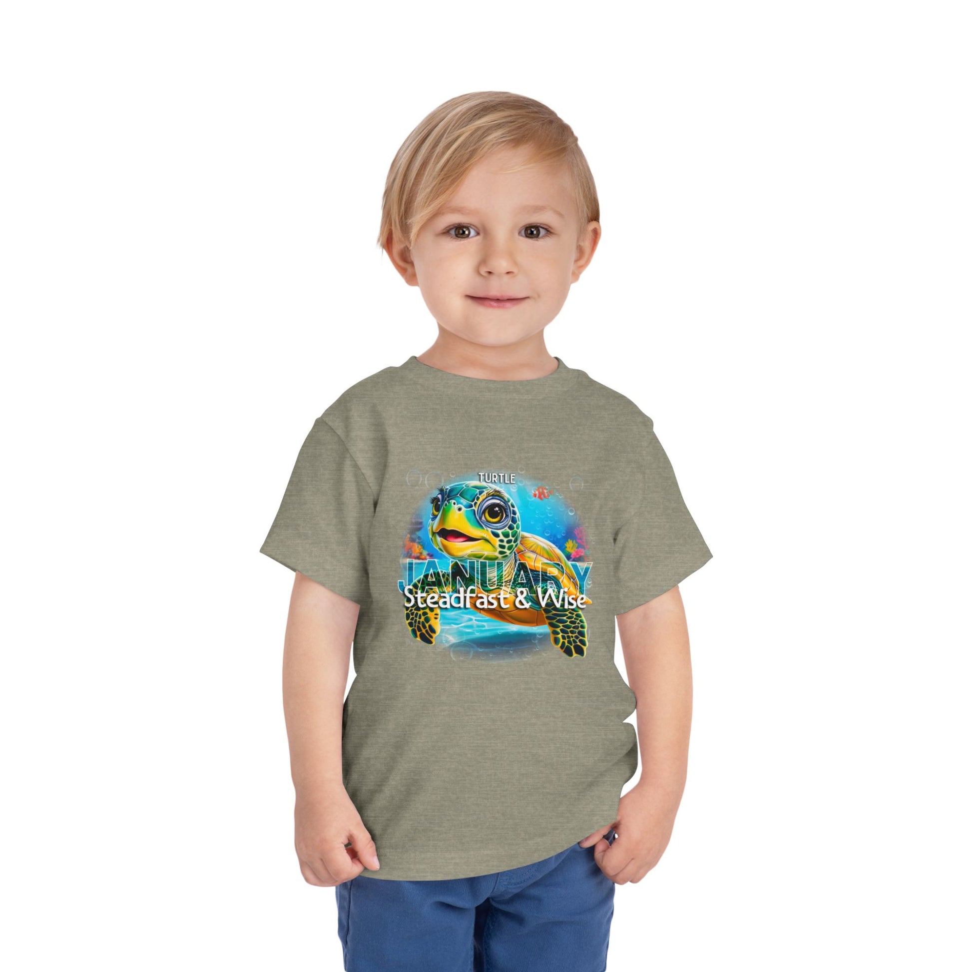 Toddler wearing kids birth month tshirt with colorful turtle design for January