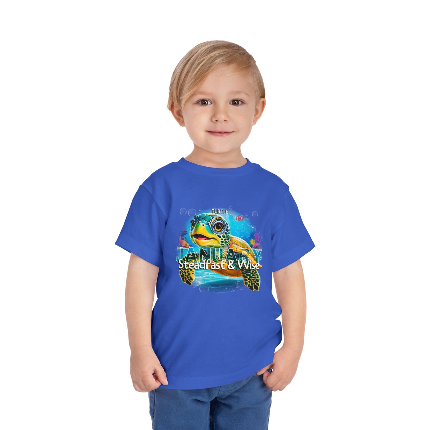 Toddler wearing blue kids birth month tshirt featuring a colorful turtle design for January