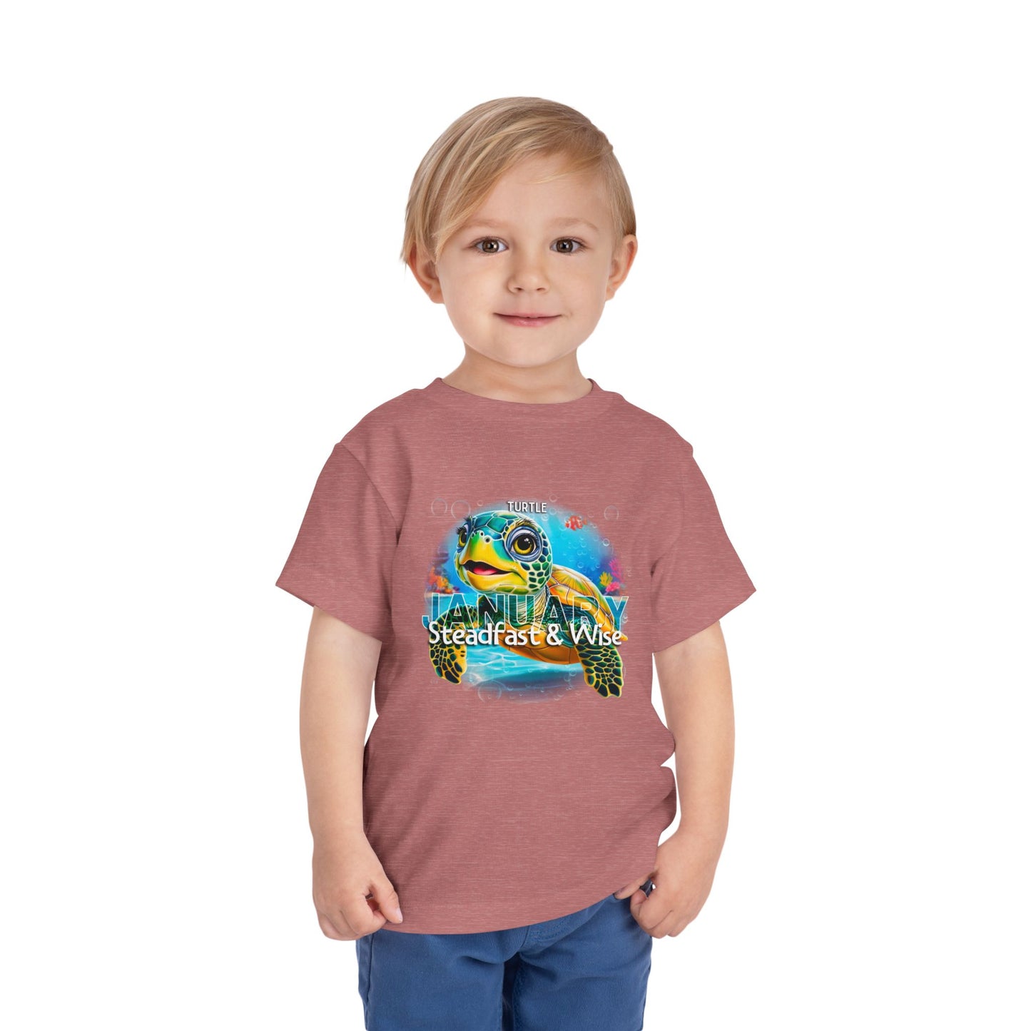 Toddler wearing kids birth month tshirt featuring a colorful sea turtle and January design