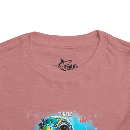 Kids birth month tshirt in pink featuring a colorful turtle design with bubbles