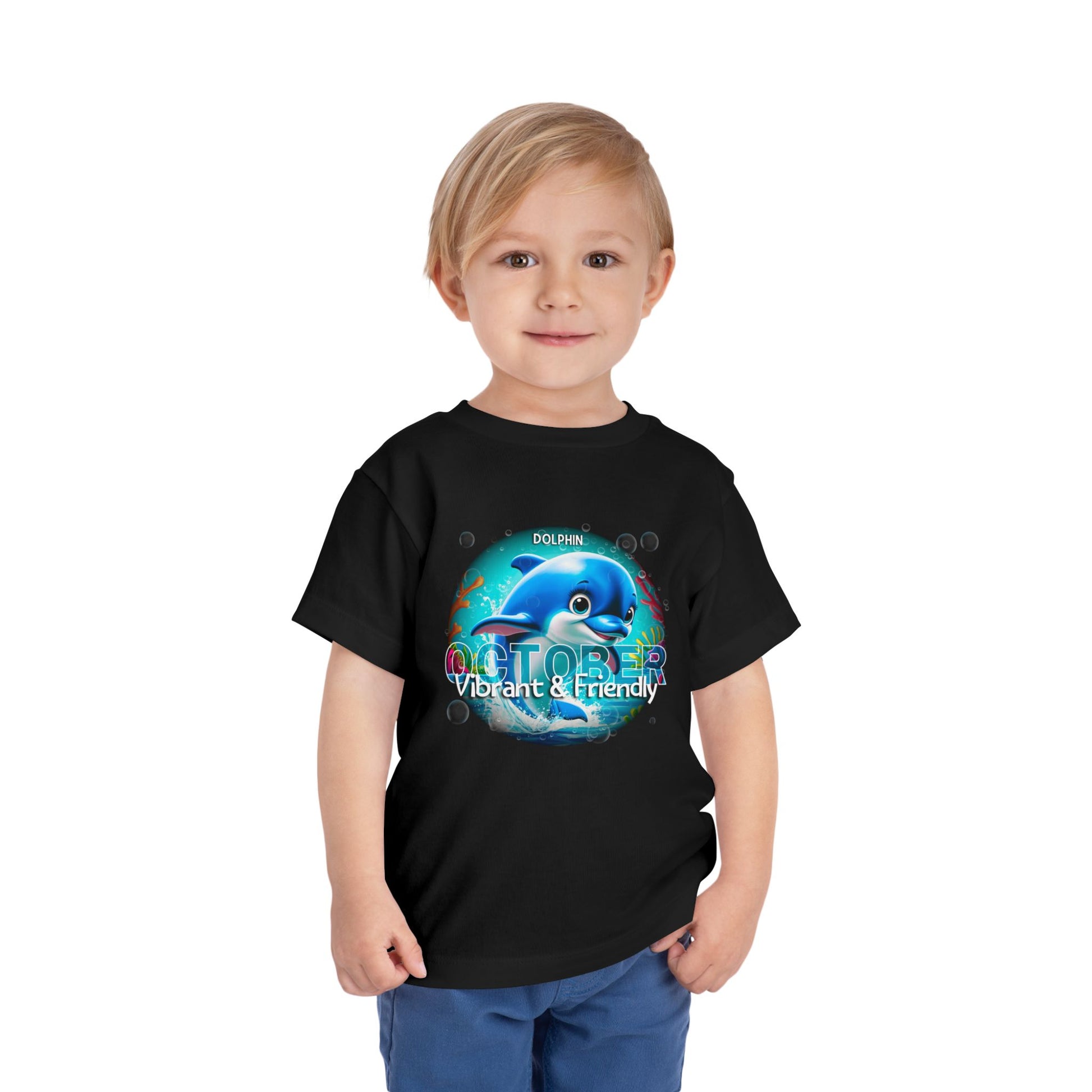 Young boy wearing a black kids birth month tshirt with October dolphin design vibrant and friendly