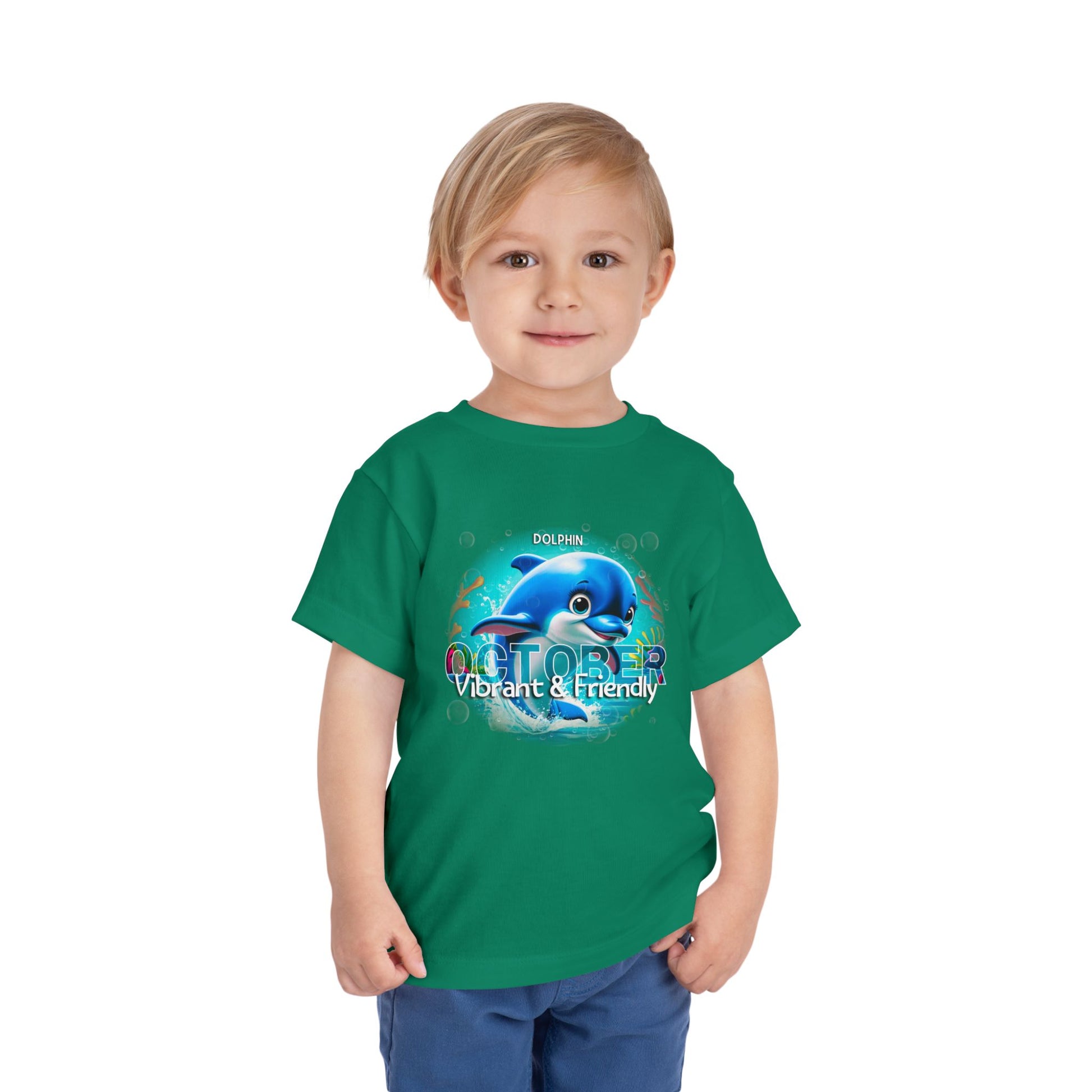 Child wearing green kids birth month tshirt with dolphin October design and vibrant friendly theme