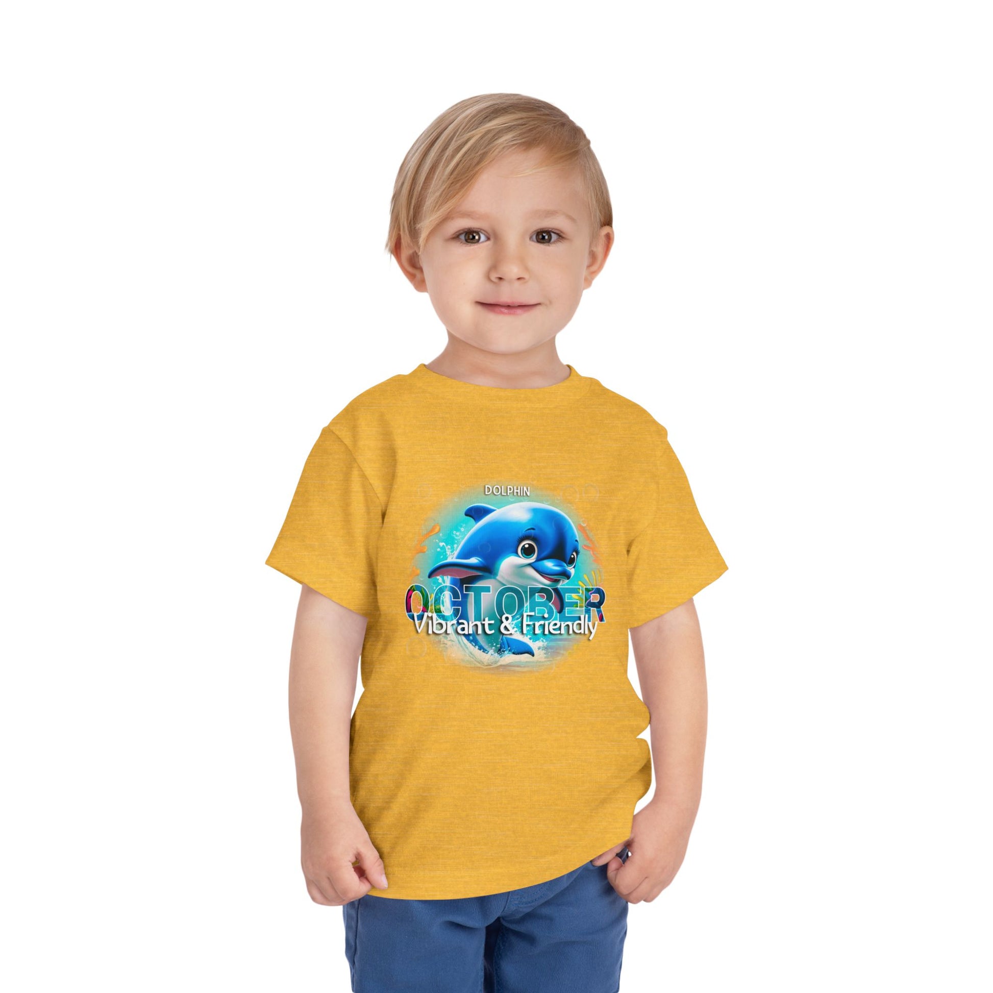 Kids birth month tshirt with October dolphin design on yellow shirt worn by toddler boy