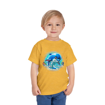 Kids birth month tshirt with October dolphin design on yellow shirt worn by toddler boy