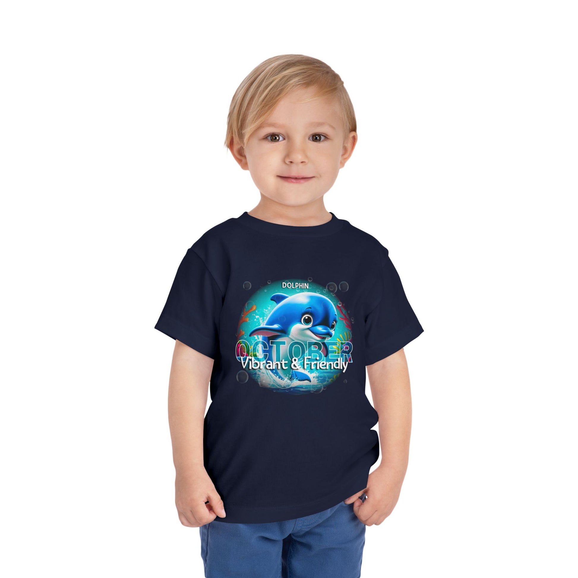 Child wearing a navy kids birth month tshirt with October dolphin design vibrant and friendly