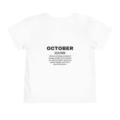 White kids birth month tshirt with October dolphin design and motivational text on back