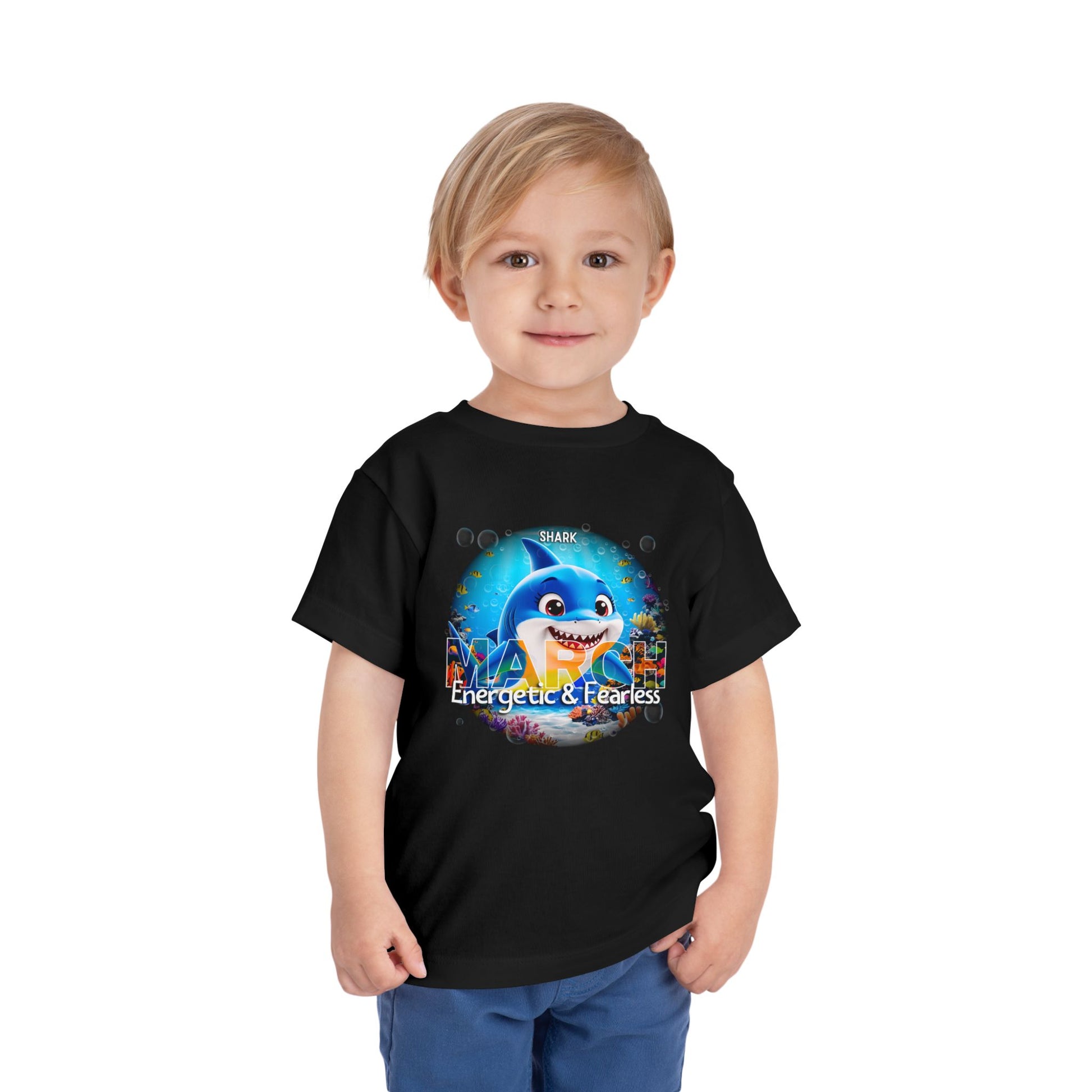 Toddler wearing black kids birth month tshirt with shark March design Energetic and Fearless