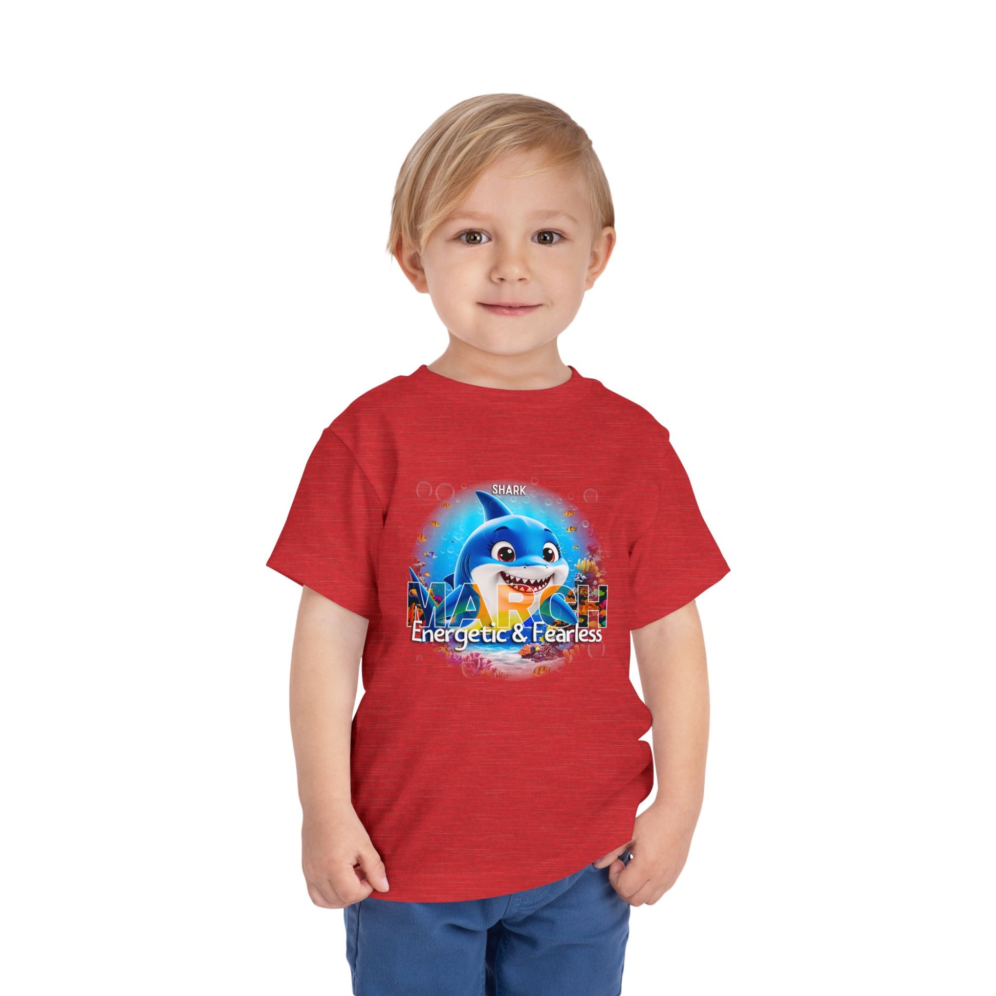 Toddler wearing red kids birth month tshirt with shark design and energetic fearless text