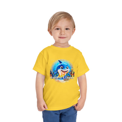 Young boy wearing a yellow kids birth month tshirt with a March shark design and fearless text
