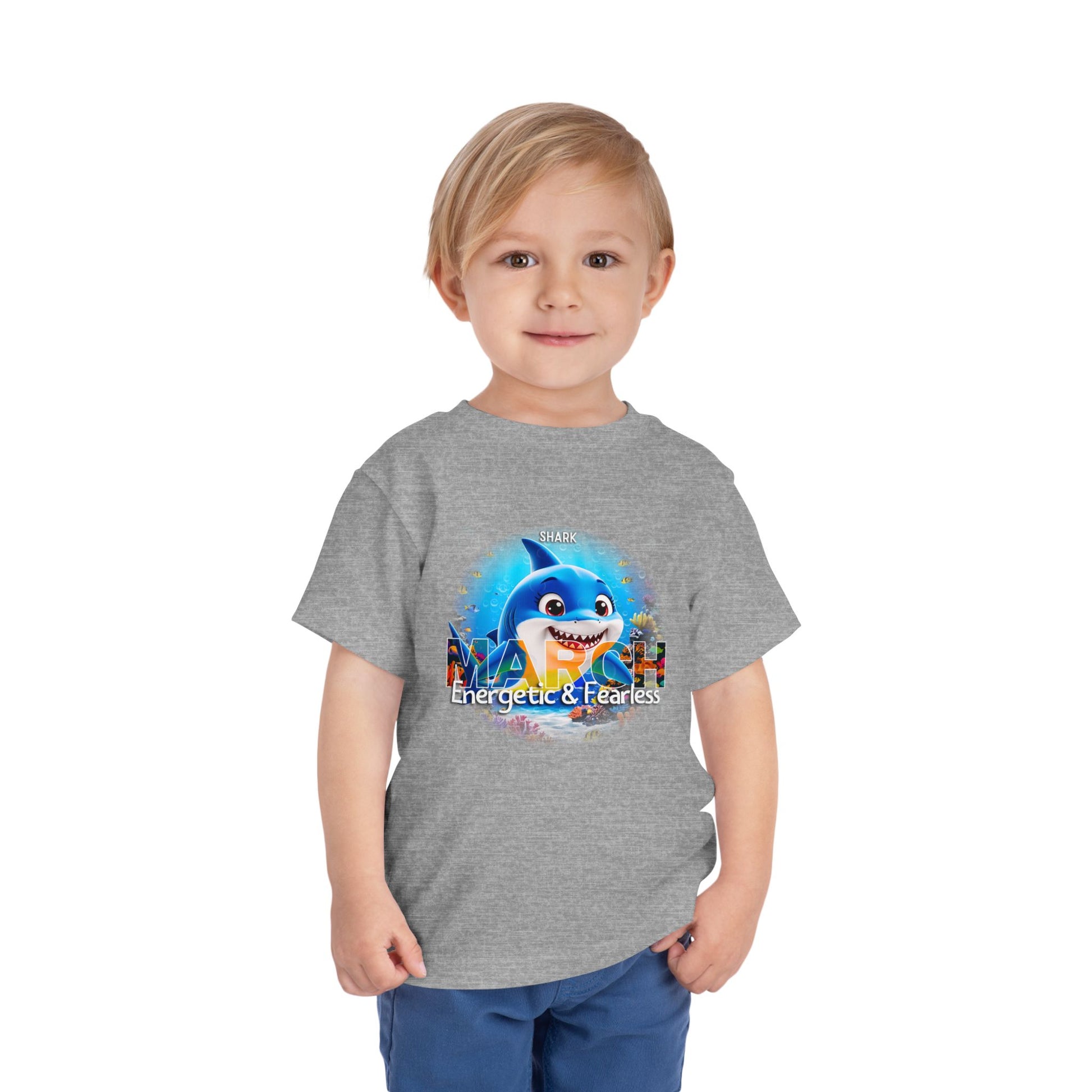Toddler wearing gray kids birth month tshirt with March shark design energetic and fearless