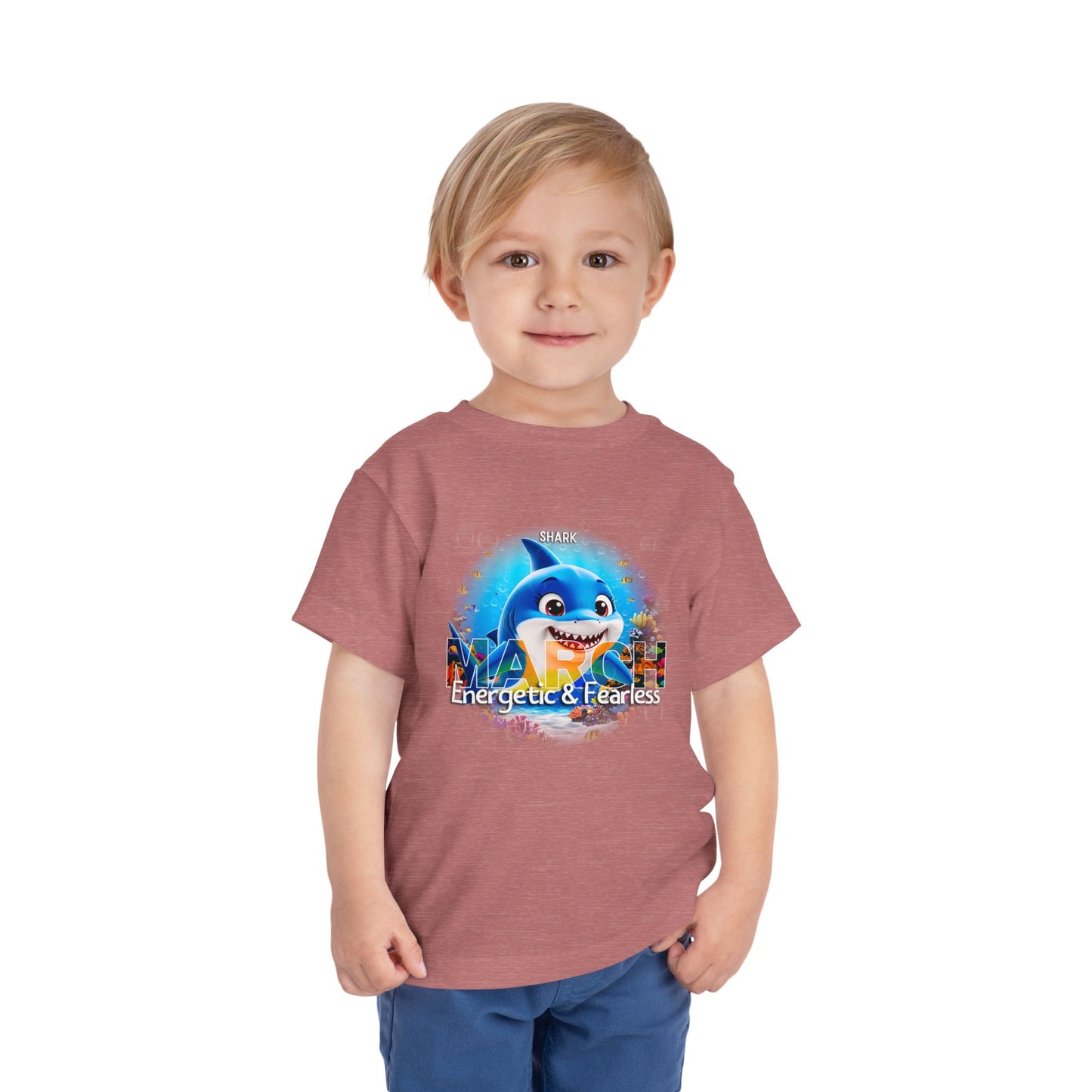 Toddler wearing a kids birth month tshirt featuring a March shark design with energetic and fearless text