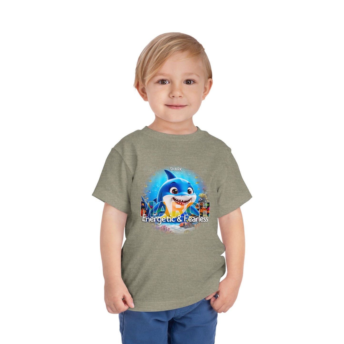 Kids birth month tshirt with energetic and fearless shark design worn by smiling toddler boy