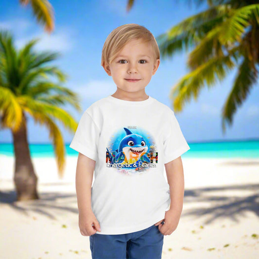 Toddler wearing a white kids birth month tshirt with March shark design on a tropical beach