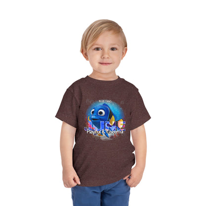 Young boy wearing kids birth month tshirt featuring playful blue tang fish graphic