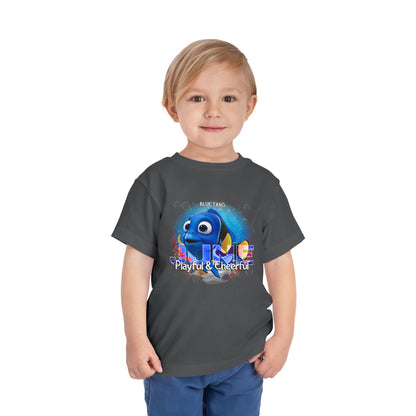 Boy wearing a kids birth month tshirt featuring a playful blue tang fish design on a dark gray shirt