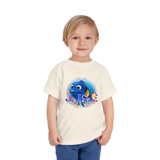 Toddler wearing a kids birth month tshirt with playful blue fish graphic and text