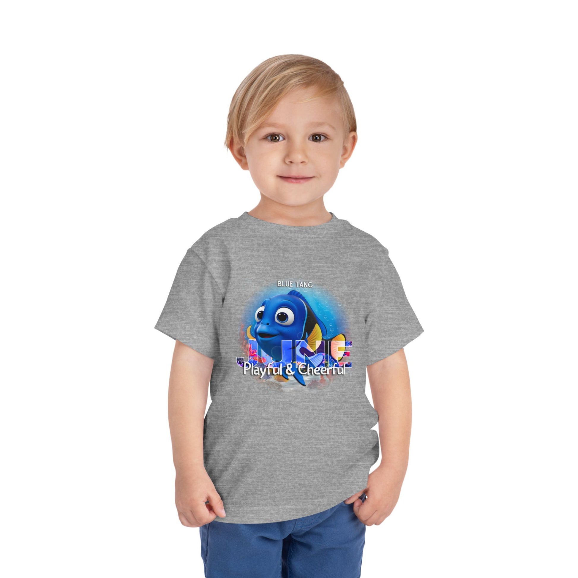 Gray kids birth month tshirt with playful colorful fish graphic worn by young boy