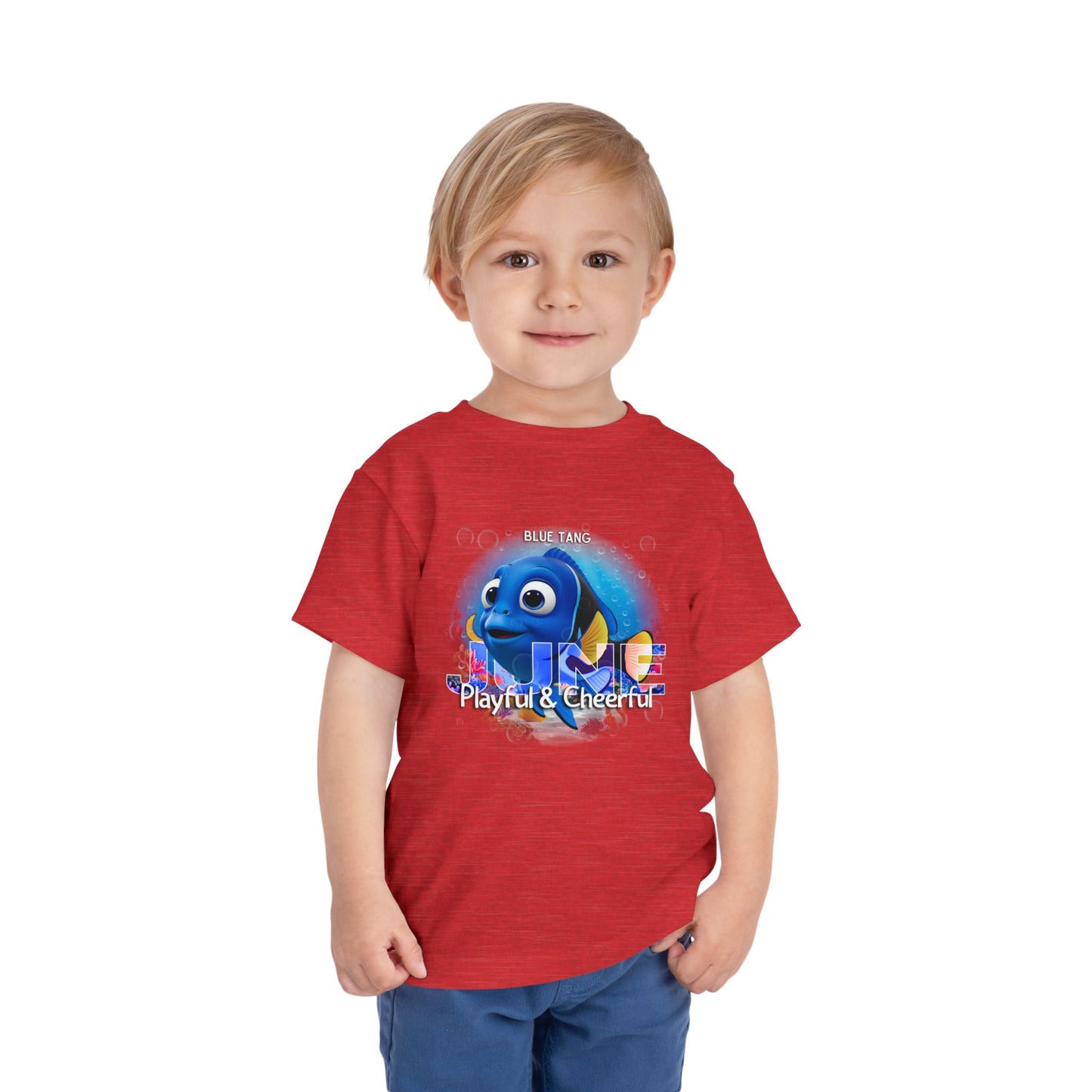 Toddler wearing a red kids birth month tshirt with a playful blue fish graphic 