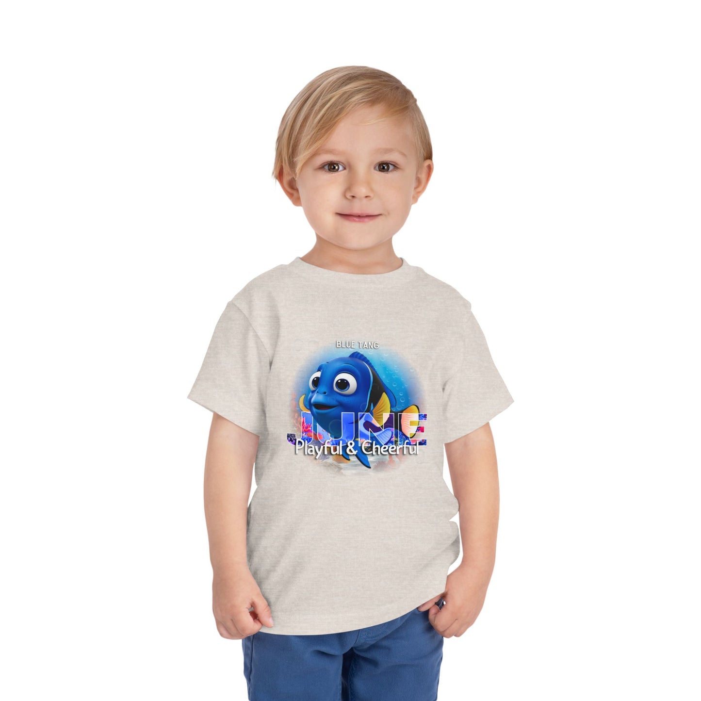 Toddler wearing a kids birth month tshirt featuring a playful blue fish graphic 