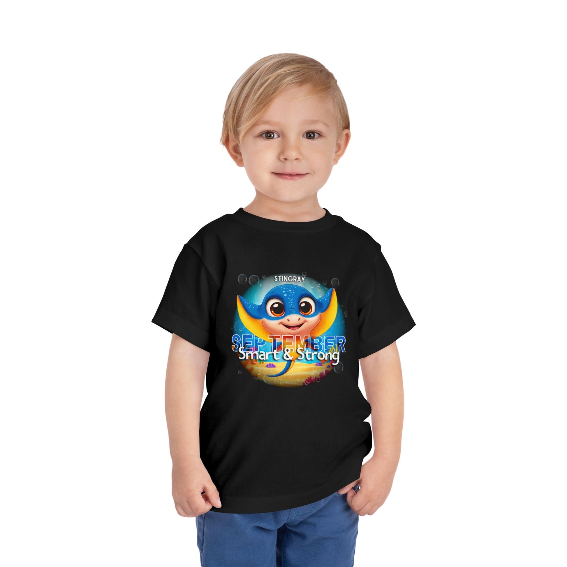 Child wearing a black kids birth month tshirt with a colorful stingray and September design