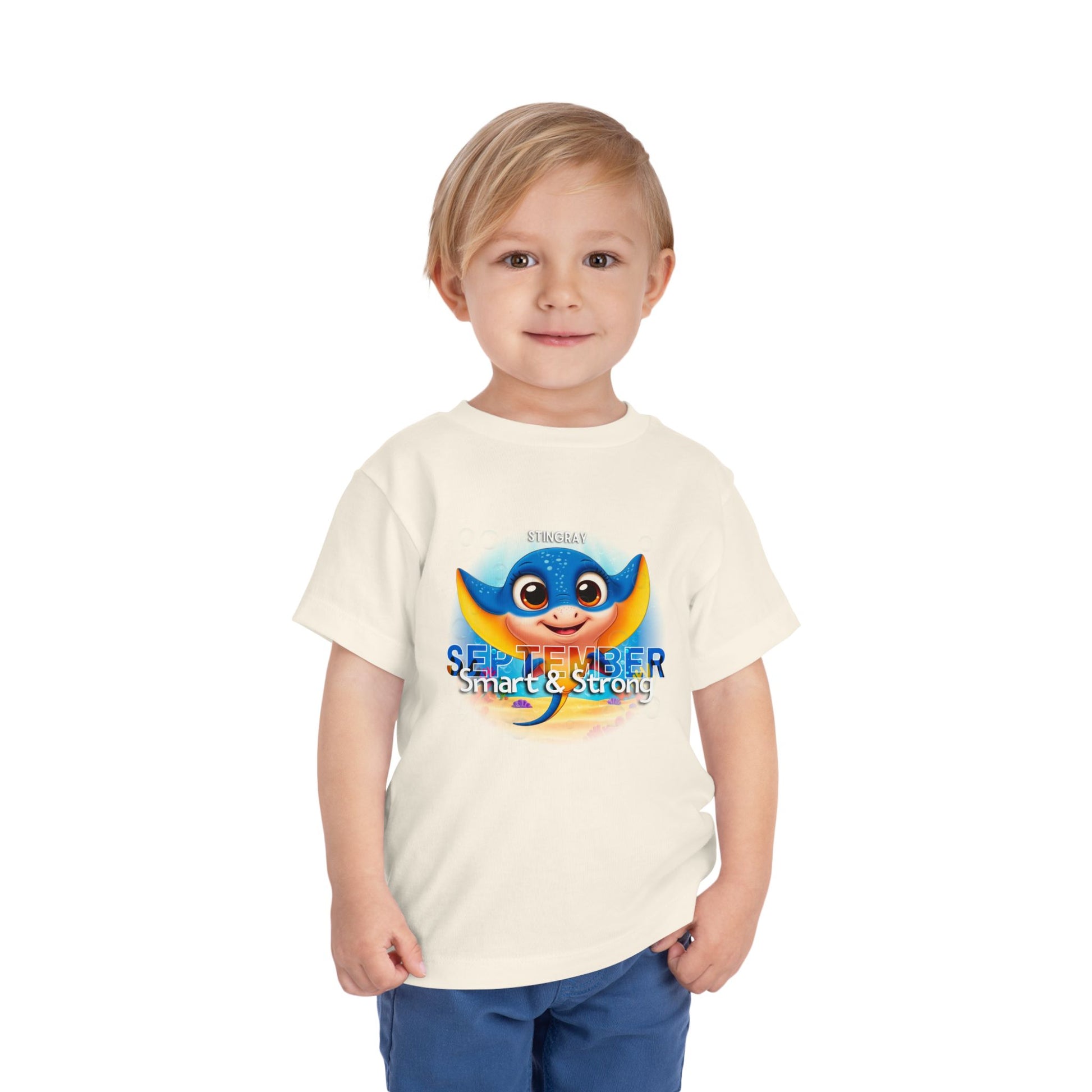 Child wearing a kids birth month tshirt with a colorful stingray design for September