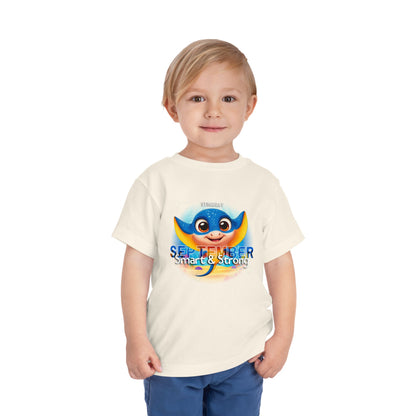 Child wearing a kids birth month tshirt with a colorful stingray design for September