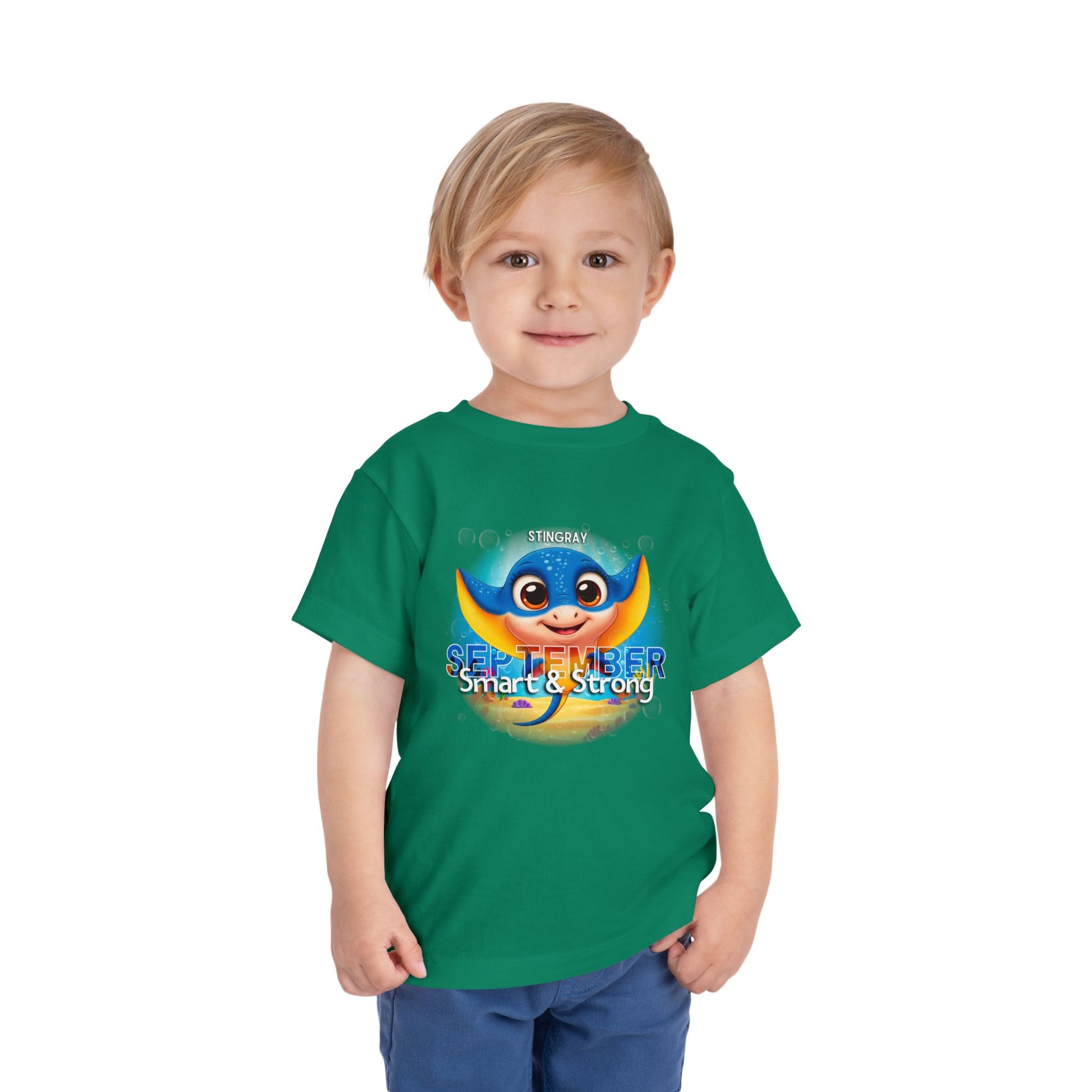 Toddler wearing green kids birth month tshirt with September stingray design 