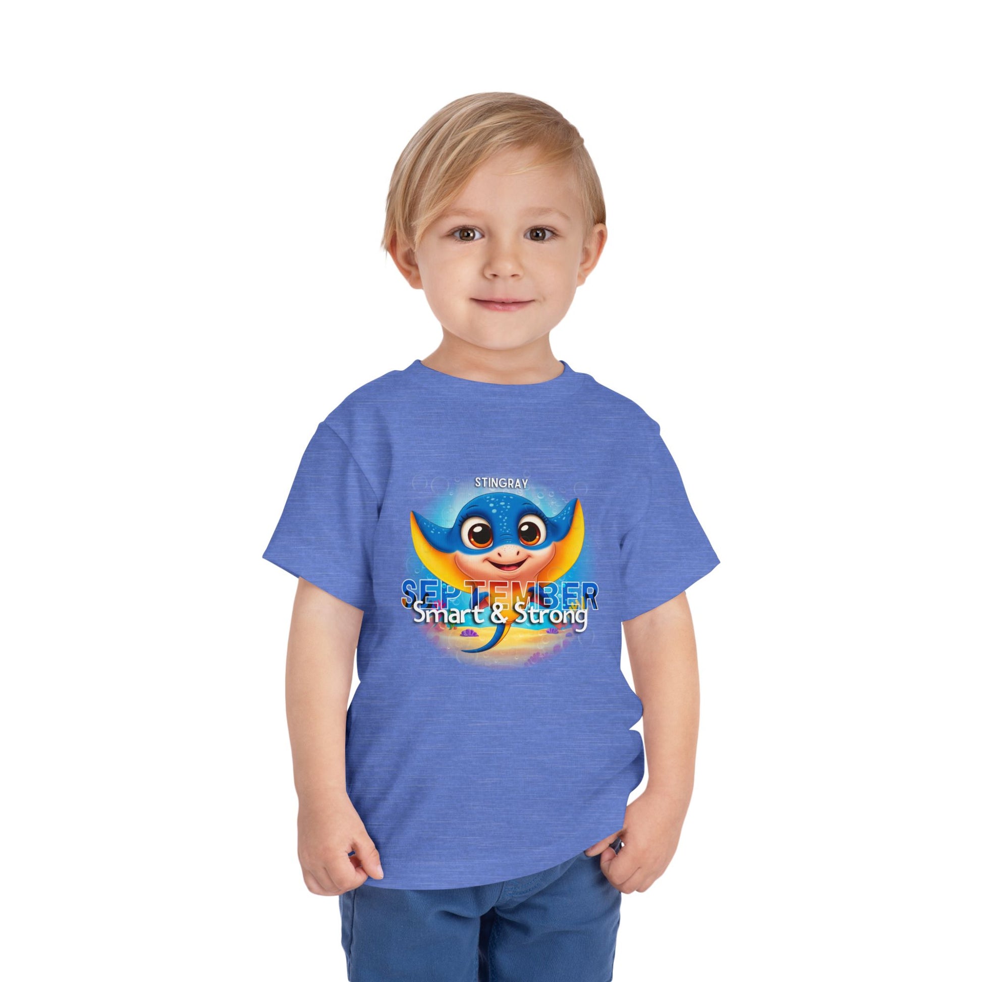 Toddler wearing kids birth month tshirt with September stingray design in blue
